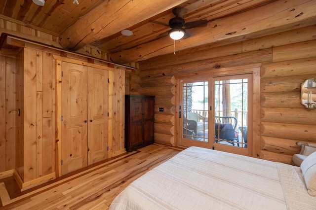 bedroom featuring light hardwood / wood-style floors, wood ceiling, log walls, and access to exterior