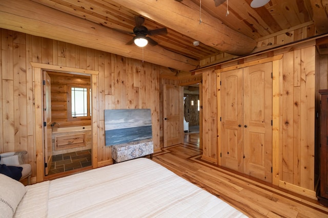 unfurnished bedroom with wood ceiling, wood walls, and wood-type flooring