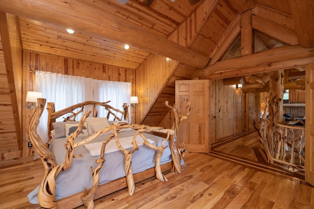 bedroom with wood ceiling, light wood-type flooring, wooden walls, and lofted ceiling with beams