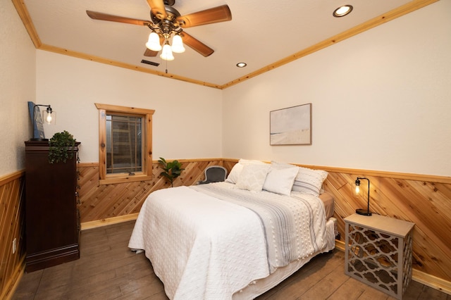 bedroom with ceiling fan, ornamental molding, and dark hardwood / wood-style floors