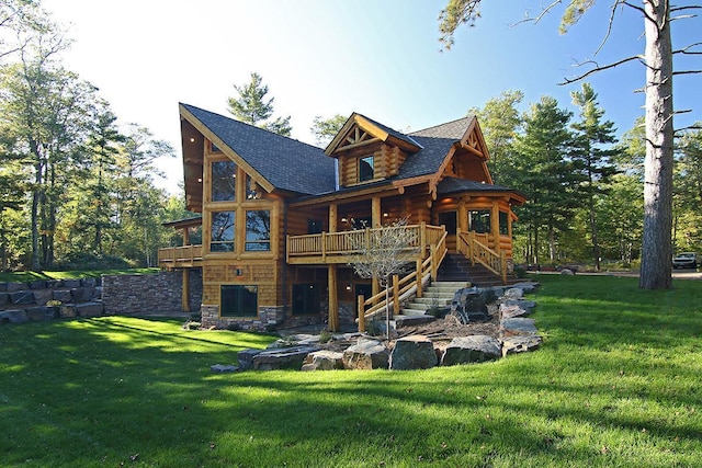 back of property with a yard and a wooden deck