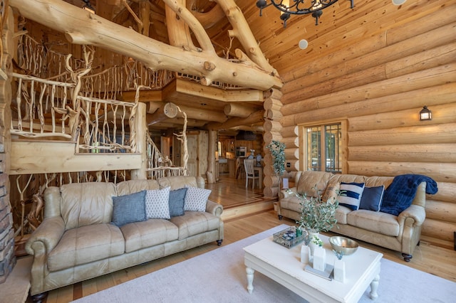 living room featuring wood ceiling, hardwood / wood-style floors, log walls, high vaulted ceiling, and beam ceiling