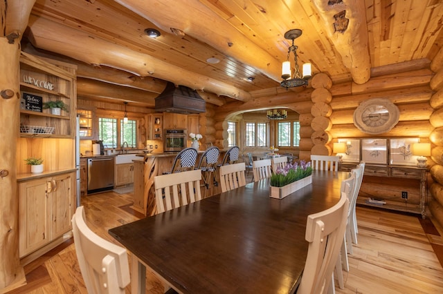 dining space featuring wooden ceiling, light hardwood / wood-style floors, log walls, a notable chandelier, and beam ceiling