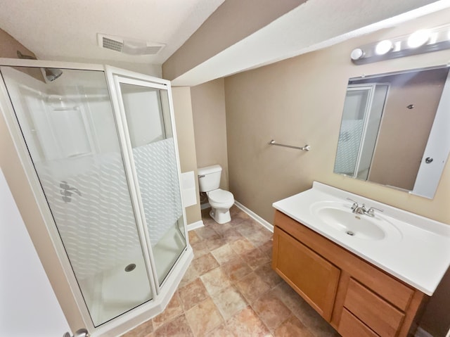 bathroom with vanity, toilet, and a shower with door