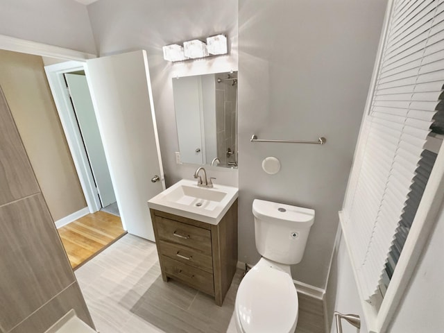 bathroom featuring vanity, toilet, and hardwood / wood-style flooring