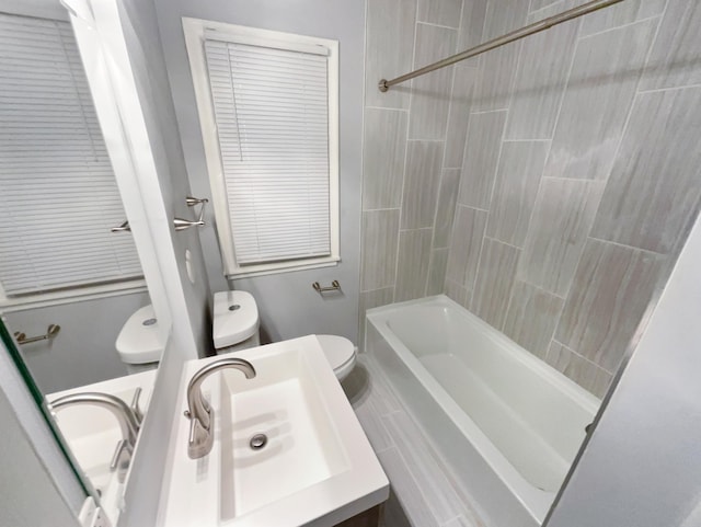 full bathroom with vanity, toilet, and tiled shower / bath