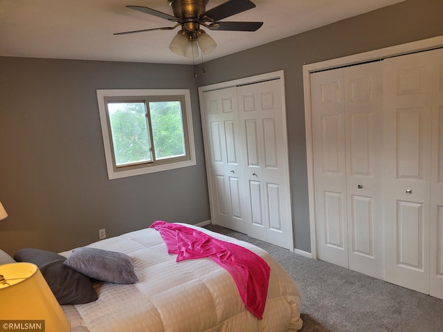 bedroom featuring ceiling fan, two closets, and carpet flooring