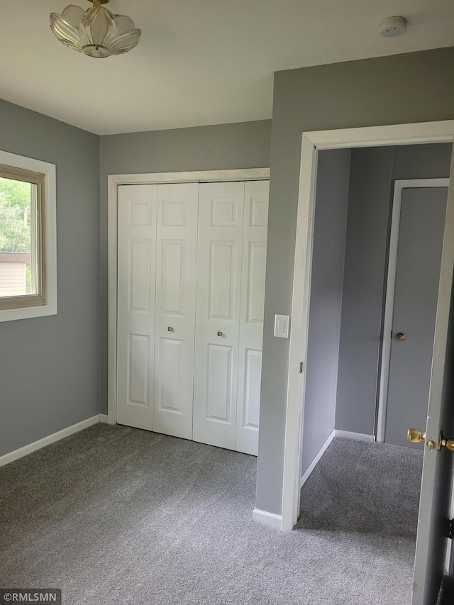 unfurnished bedroom featuring a closet and carpet flooring