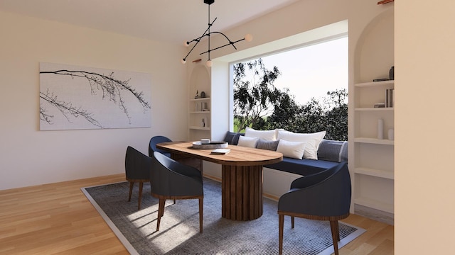 dining area with a wealth of natural light, breakfast area, and hardwood / wood-style flooring