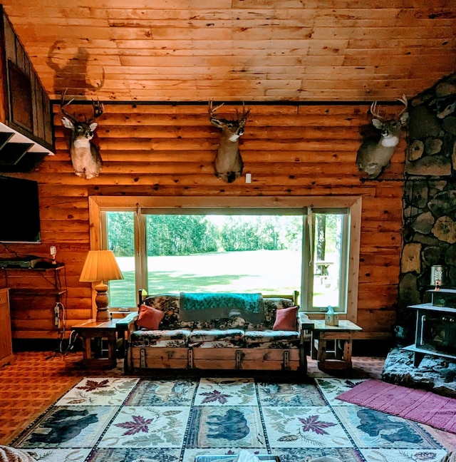 living room featuring wood ceiling, rustic walls, hardwood / wood-style floors, and plenty of natural light