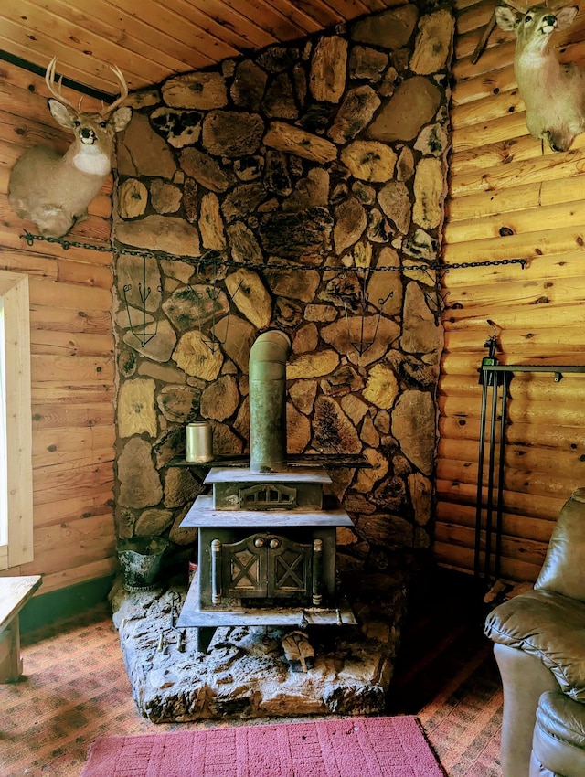 room details with wood ceiling, hardwood / wood-style flooring, and a wood stove