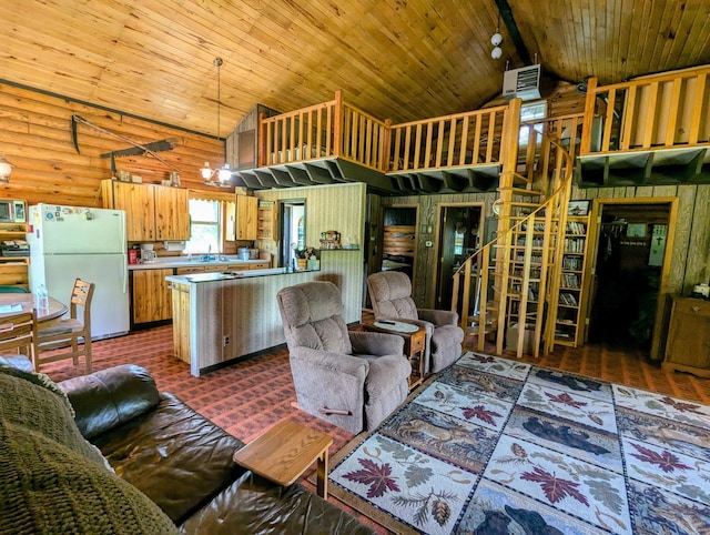 kitchen featuring vaulted ceiling with beams, kitchen peninsula, pendant lighting, an inviting chandelier, and white refrigerator