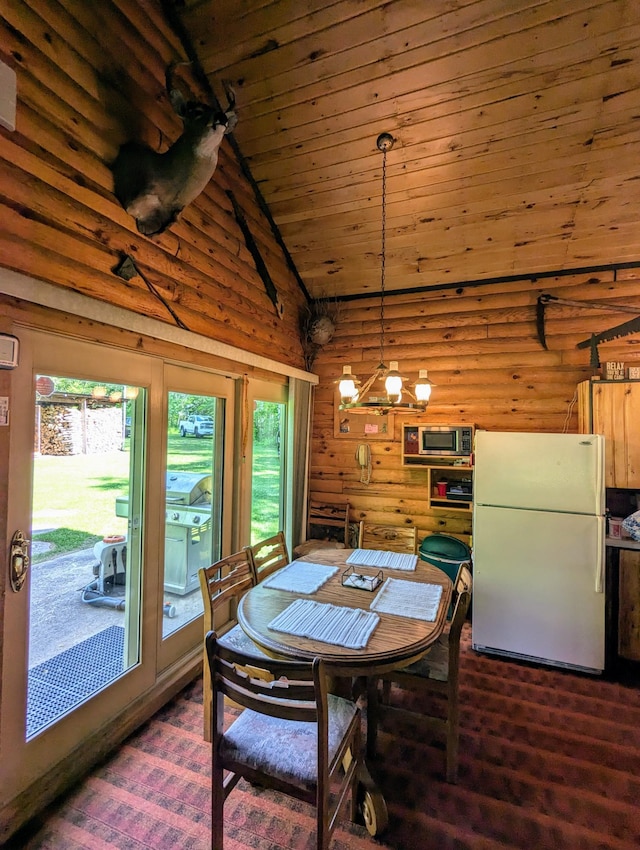 dining space with a wealth of natural light, wooden ceiling, and dark hardwood / wood-style flooring