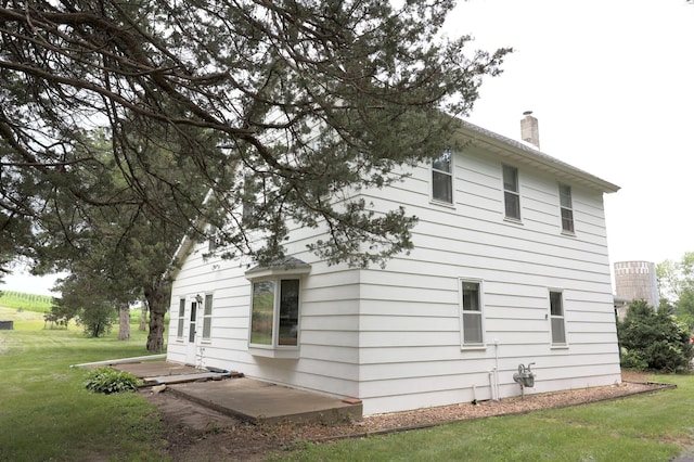 view of property exterior with a yard