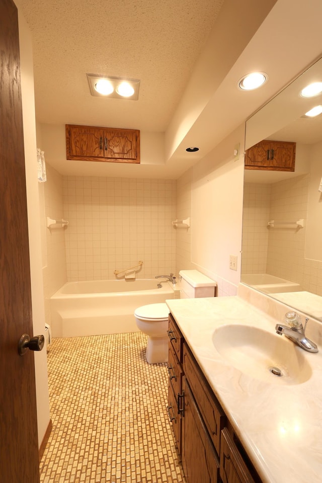 bathroom featuring tile patterned floors, toilet, a textured ceiling, and vanity