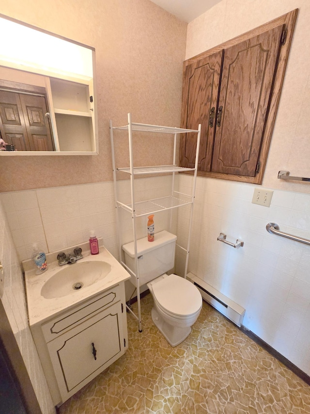 bathroom featuring baseboard heating, tasteful backsplash, tile patterned flooring, vanity, and toilet