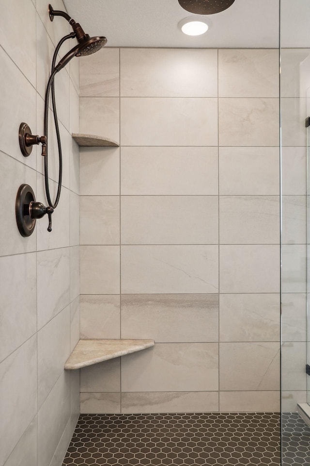 bathroom with a tile shower