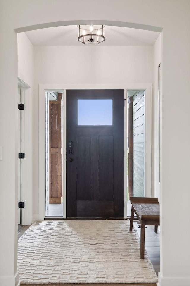 foyer featuring a chandelier