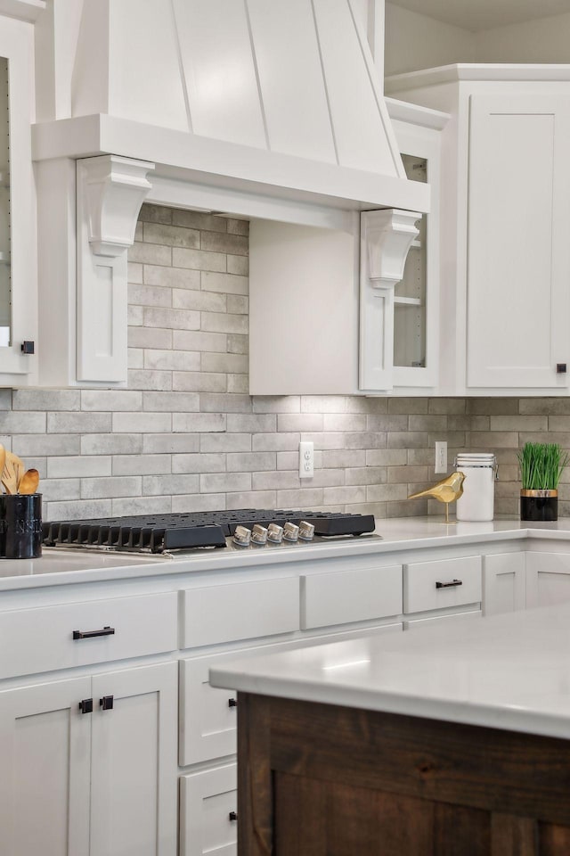 kitchen featuring backsplash and white cabinets