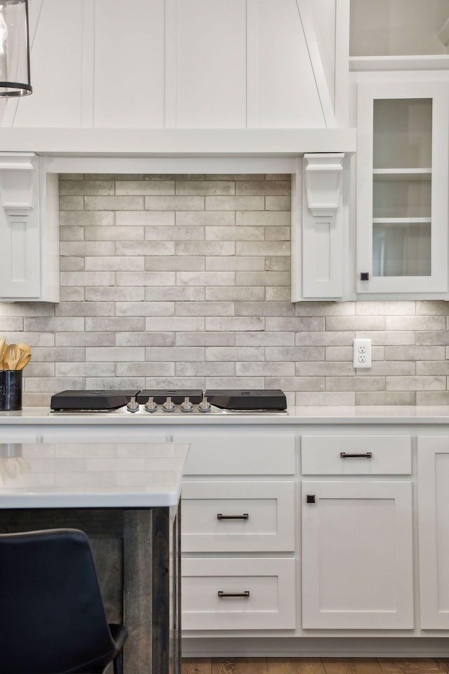 kitchen featuring decorative backsplash and white cabinets