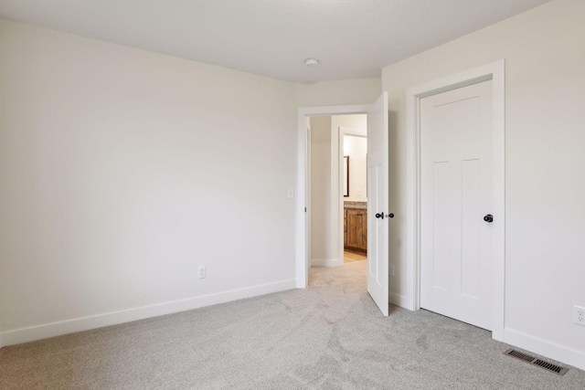 unfurnished bedroom with light carpet