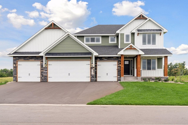 craftsman inspired home featuring a garage and a front yard