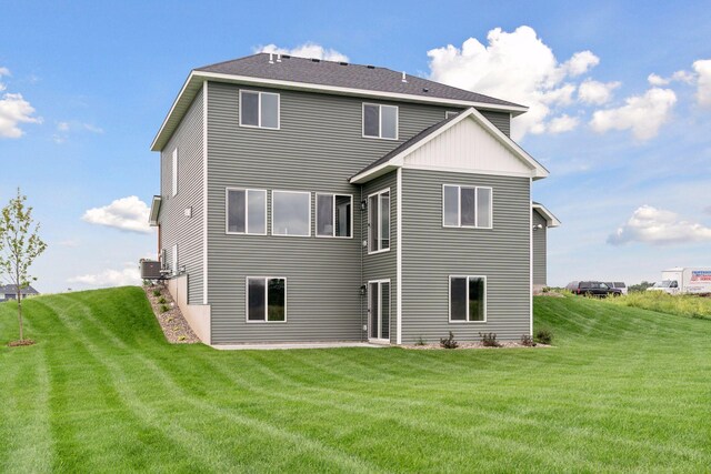 rear view of house featuring a yard