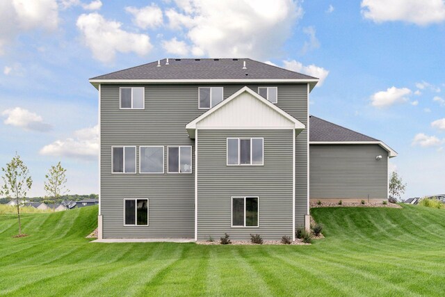 rear view of property with a lawn