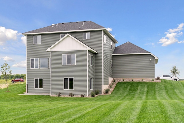 rear view of property featuring a yard