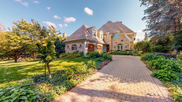 french country style house featuring a front yard