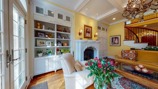 interior space featuring coffered ceiling, a notable chandelier, ornamental molding, light hardwood / wood-style flooring, and beam ceiling