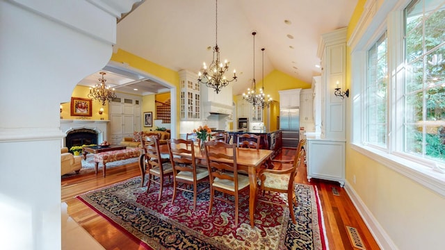 dining room with a chandelier, hardwood / wood-style floors, and a healthy amount of sunlight