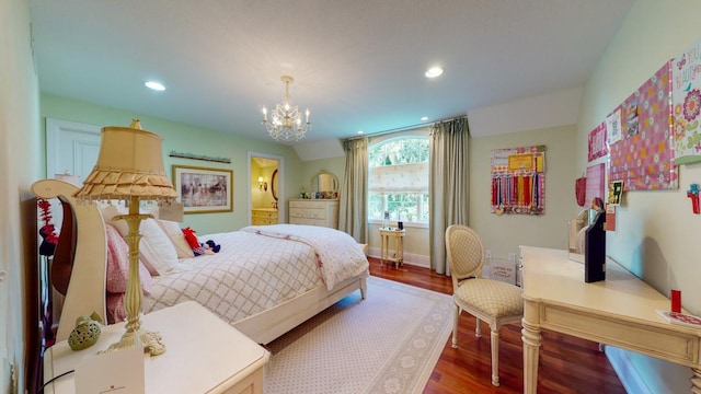 bedroom with hardwood / wood-style flooring and a chandelier