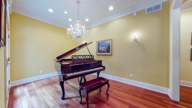 misc room featuring crown molding, an inviting chandelier, and wood-type flooring