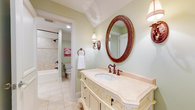 full bathroom featuring tile patterned flooring, toilet, tiled shower / bath, and vanity