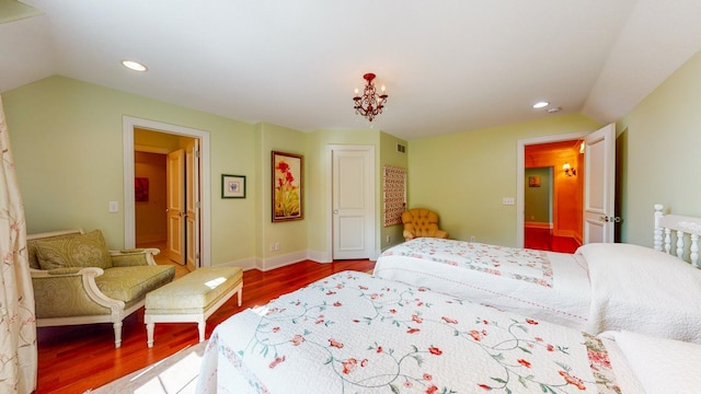 bedroom featuring lofted ceiling and hardwood / wood-style floors