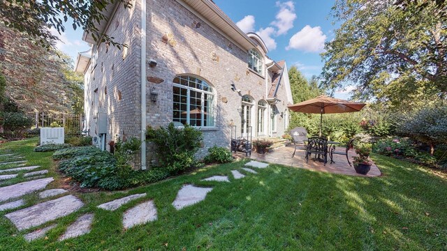 back of house featuring a yard and a patio