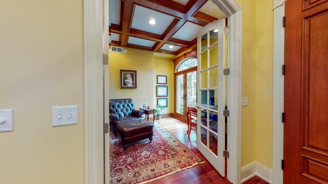 sitting room with french doors, coffered ceiling, hardwood / wood-style flooring, and beam ceiling