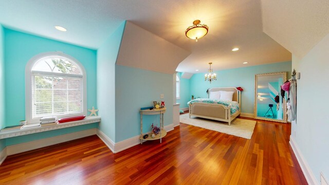 bedroom featuring wood-type flooring and a notable chandelier