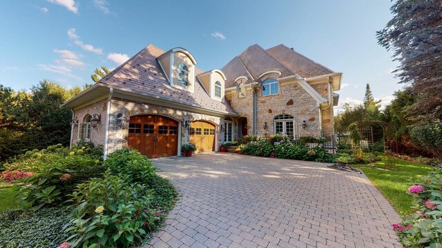 french country home featuring a garage