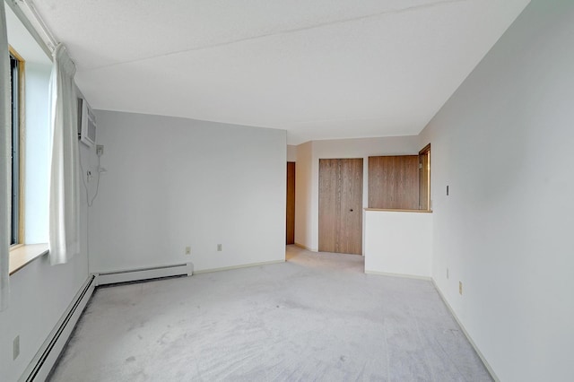 unfurnished bedroom with a baseboard radiator and light colored carpet