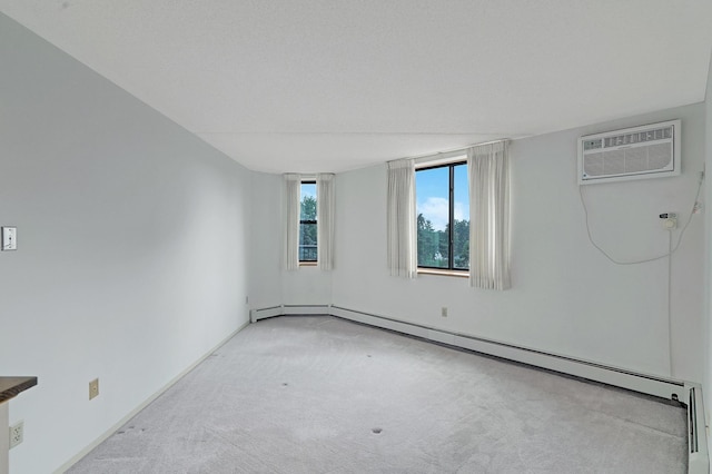 unfurnished room with a wall mounted AC, light carpet, and baseboard heating