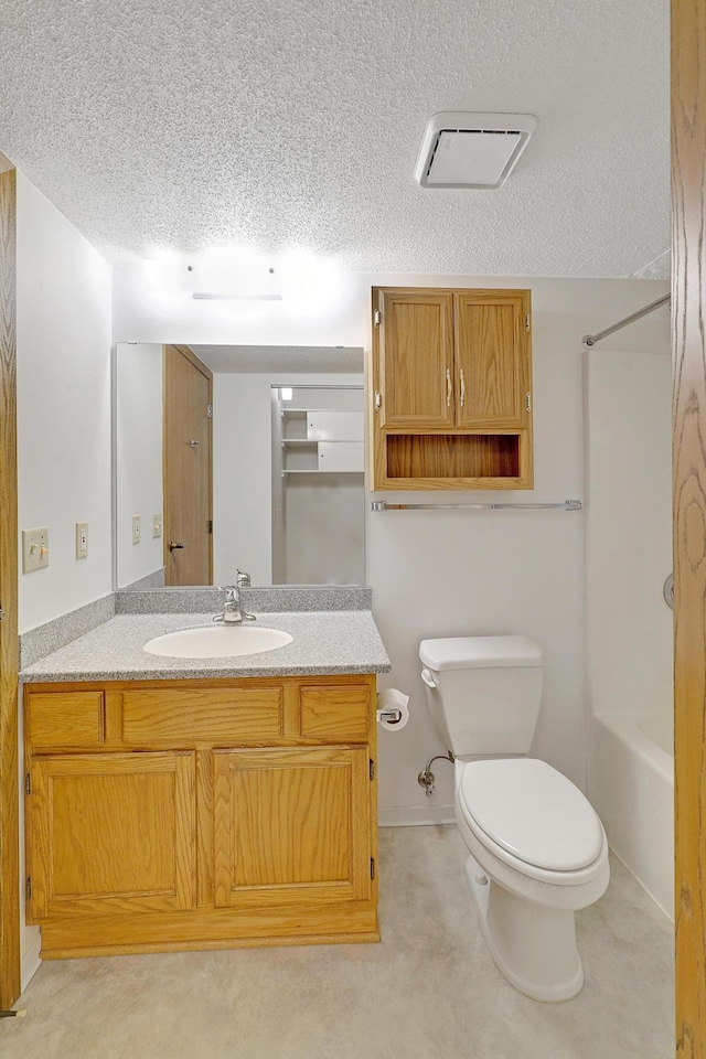 full bathroom with a textured ceiling, vanity, toilet, and washtub / shower combination