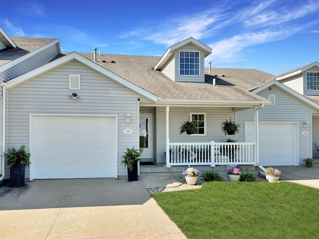 view of front facade featuring a garage, a front lawn, and a porch