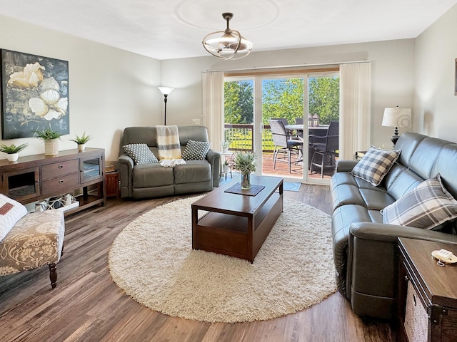 living room with hardwood / wood-style floors and a notable chandelier