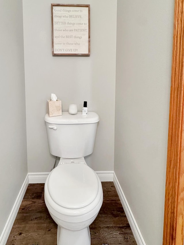 bathroom with hardwood / wood-style floors and toilet