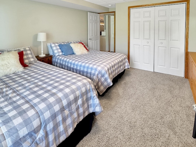 bedroom with a closet and light carpet