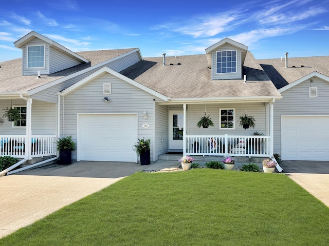 cape cod home with a garage, a front yard, and covered porch