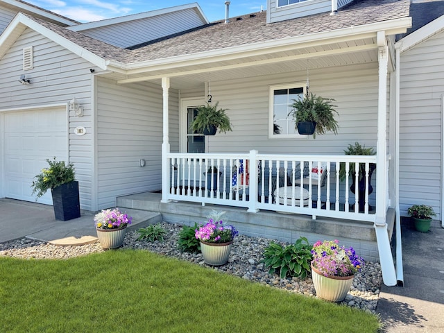 exterior space with a garage and covered porch