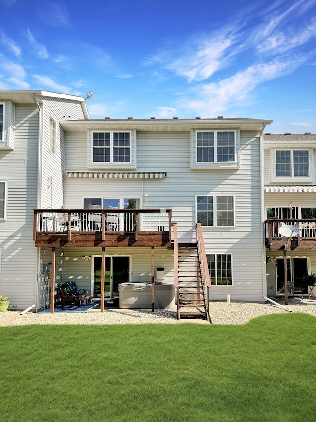 rear view of house with a wooden deck and a yard